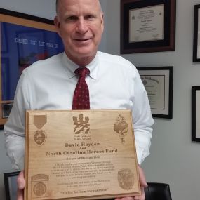 Former NC Heroes Fund Chairman David Hayden receives a Thank You Plaque from an NC Heroes Fund Awards Recipient.